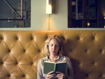 Blond woman reading a book