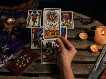 Close-up of a fortune teller reading tarot cards