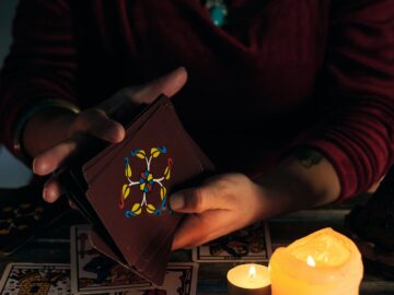 Pythoness woman shuffles tarot cards