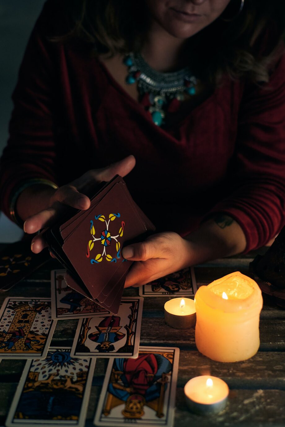 Pythoness woman shuffles tarot cards