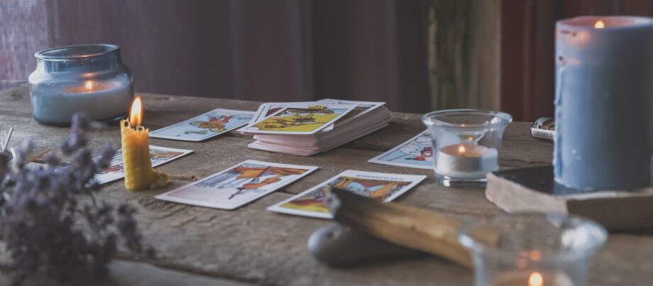 Tarot cards, Fortune telling on tarot cards at night by candlelight, magic crystal, occultism,