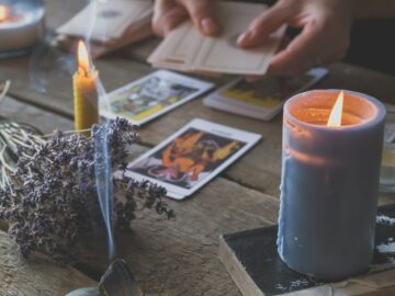 Tarot cards, Fortune telling on tarot cards at night by candlelight, magic crystal, occultism