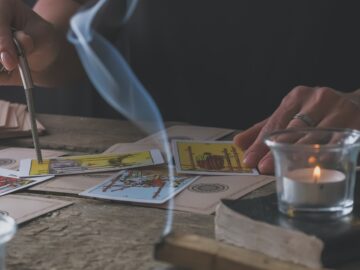 Tarot cards, Fortune telling on tarot cards at night by candlelight, magic crystal, occultism