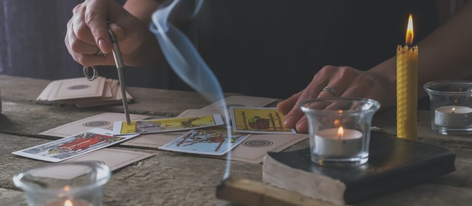 Tarot cards, Fortune telling on tarot cards at night by candlelight, magic crystal, occultism