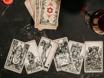 Tarot cards on red background, occult and magic