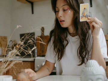 woman with tarot cards at home