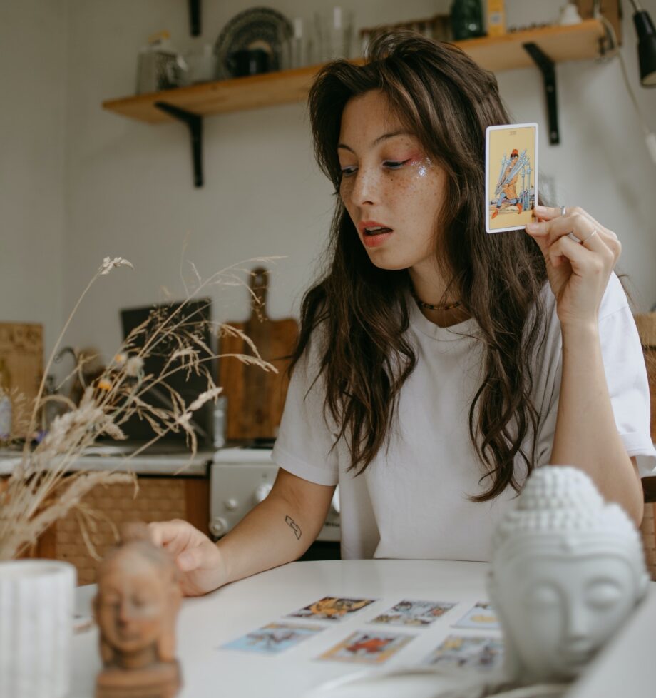 woman with tarot cards at home